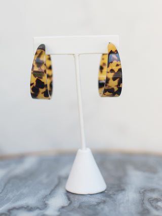 a pair of lightweight amber tortoise shell hoop earrings in acrylic perfect for everyday jewelry wear