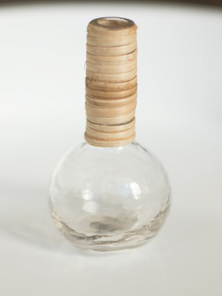 small clear circular vase with long wrapped neck