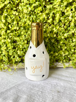 ceramic champagne decorative sitter that sparkles with gold and light