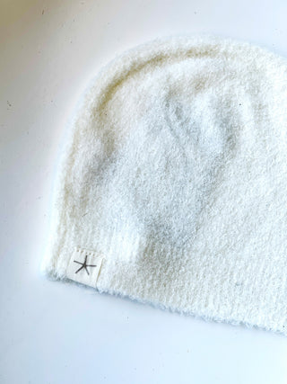 soft barefoot dream baby beanie in light white color