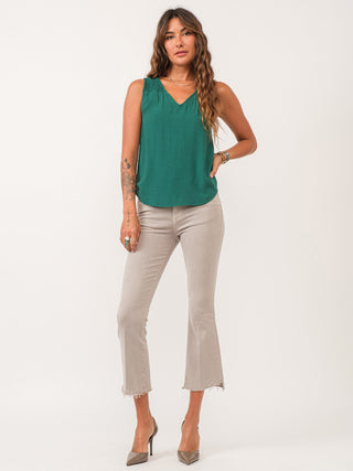 silky soft relaxed fit tank with shirred details and a vivid green color worn with khaki pants