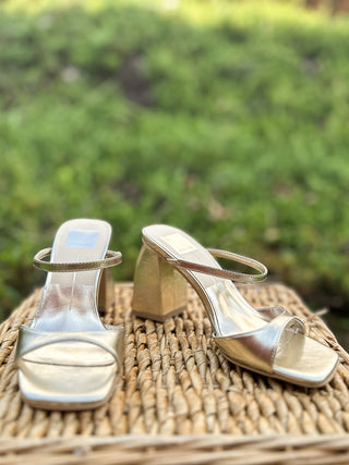 a pair of gold metallic strappy block heels in a slip on style perfect for weddings and cocktail parties