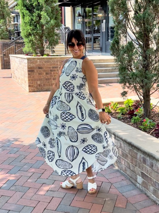 breezy white maxi dress with a fun fruity print in navy blue and back tie perfect for the beach