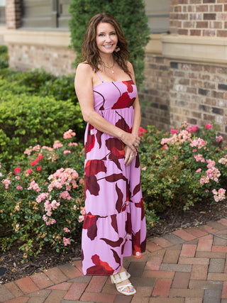 a lavender and dark red floral maxi dress with spaghetti straps and a square neck shown with white heels