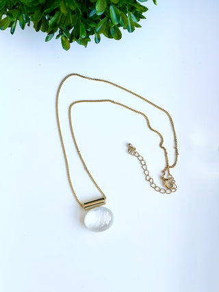 crafted white pebble charm necklace on a gold chain with lobster clasp
