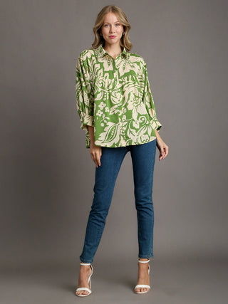 relaxed fit collared blouse in a green floral print pattern worn with blue jeans