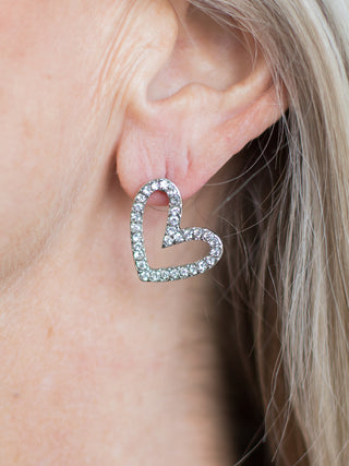 a pair of silver rhinestone open heart earrings