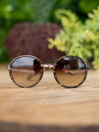 circular vintage shape sunglasses in a tortoise shell pattern