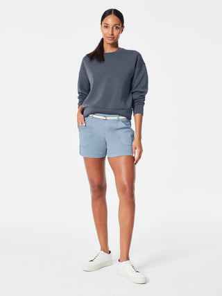 mountain blue soft spanx stretch twill shorts with tummy shaping fabric worn with gray sweatshirt