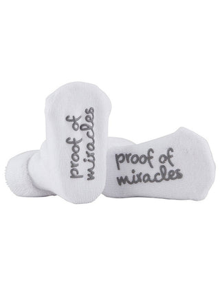 darling white stephan baby socks with sentimental note reading proof of miracles