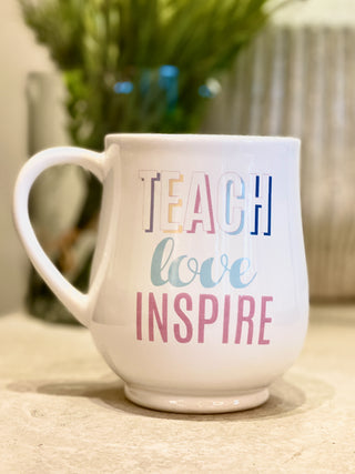 white ceramic coffee mug for teacher appreciation that reads teach love inspire