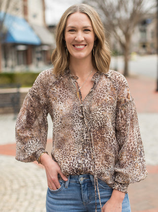 a flowy long sleeve leopard print button front top with tie