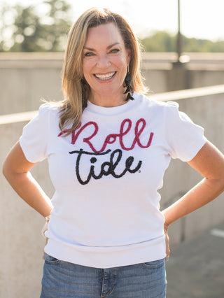 a white sweater tshirt with red and black glitter text that reads roll tide perfect for bama fans and football fashion 