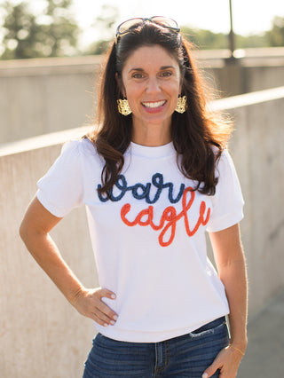 a white sweater tshirt with blue and orange glitter text that reads war eagle perfect for auburn tigers football fans 
