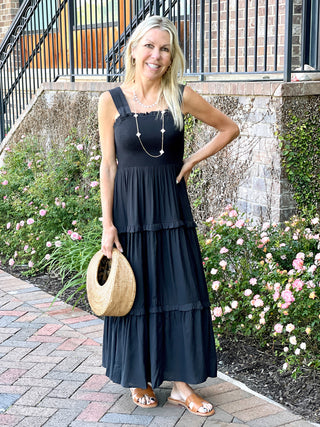 a breezy black sleeveless midi sundress with square neckline and lightweight tiers