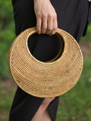 handcrafted balinese round basket purse made of woven ata vine in crescent moon shape with golden color and smoke cured