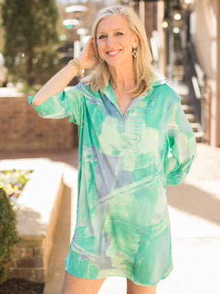 a multicolor green mini shirt dress with three quarter sleeves and watercolor design