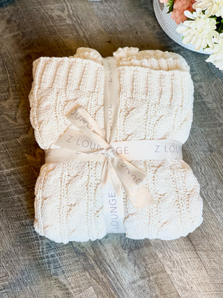 a big plush cream blanket for staying cozy or gifting