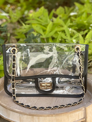stadium-approved clear bag with black and gold link woven straps and a secure twist lock closure featuring gold hardware
