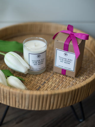 a hand poured coconut sugar and sandalwood candle and gift box with thank you for being my mom printed on both