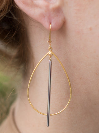lightweight two-tone dangle earrings with teardrop gold hoops and a contrasting silver stake that sways with motion