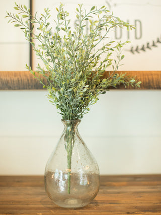 an artificial green basil boxwood bush plant in a glass vase for fake plant home decor