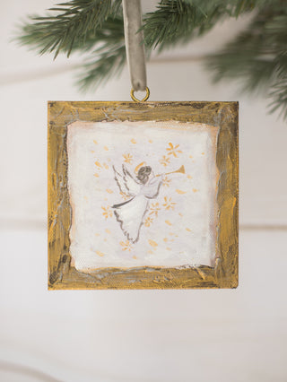 a gold wooden box ornament with an angel painting