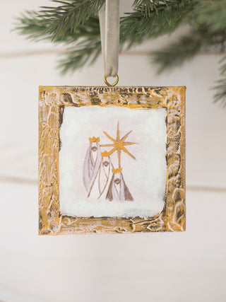 a gold wooden box ornament with a nativity scene painting