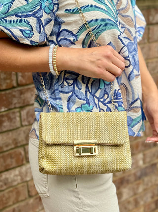 tan straw bag with double gold twist closure 