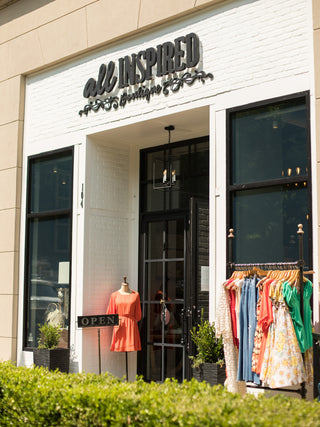 exterior storefront with open doors and an open sign to welcome customers