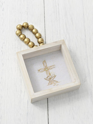 a white wood ornament box with gold beads and a manger picture