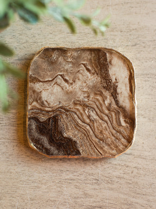 a brown and gold coaster featuring an agate crystal design for luxurious home decor and hostess gifts