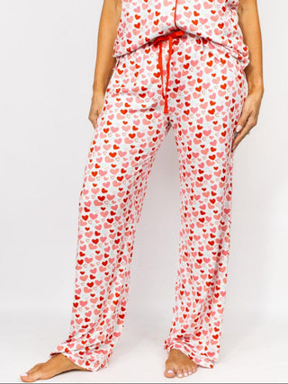 a pair of soft valentine heart pajama lounge pants with a red tie at the waist