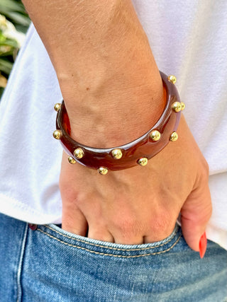 glossy amber brown bangle bracelet with gold studs