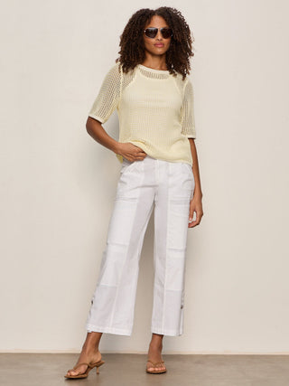 a pair of lightweight white cargo pants worn with a yellow top