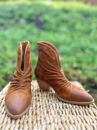 a pair of brown suede boots with ruching and a pointed toe with block heel perfect for versatile fall fashion