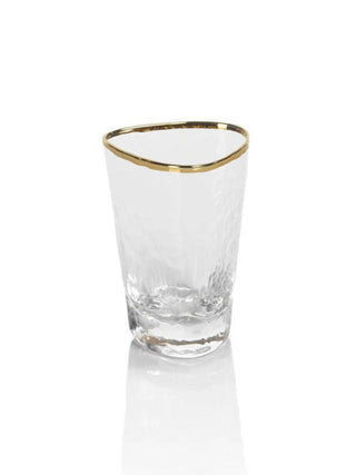 a triangular hammered glass shot glass with a golden rim