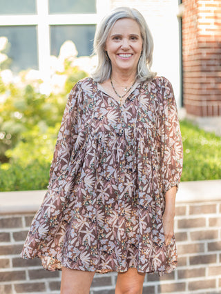 a brown floral mini dress with long flowing sleeves perfect for boho fall fashion to pair with boots or tights