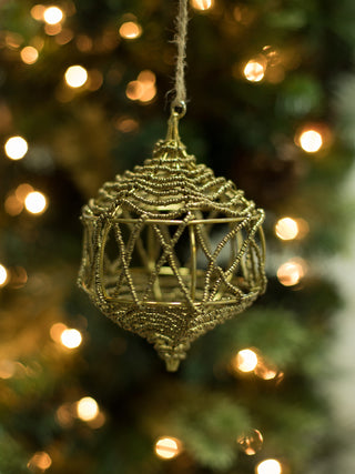an unbreakable christmas ornament made of gold wire and beads is perfect for holiday decor and host gifts