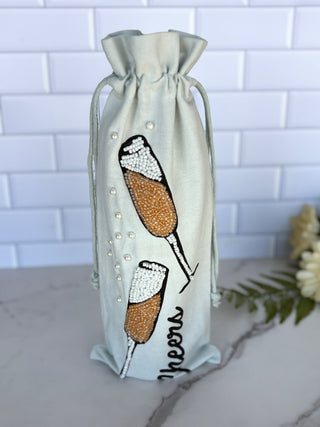 white beaded wine bag with champagne glasses 