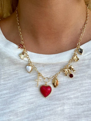 gold necklace with white and red hearts and a football charm for alabama spirit