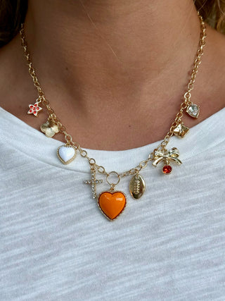gold necklace with orange and white hearts and a football charm for tennessee spirit