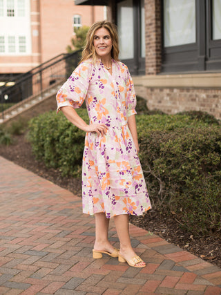 pleated skirt bubble sleeve floral print midi dress in pink worn with tan low heel sandals