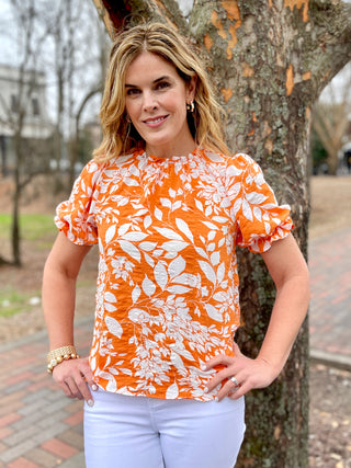bright orange floral crinkle fabric top with short puff sleeves