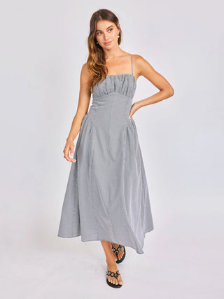 Woman wearing a gray strapless dress on a white background