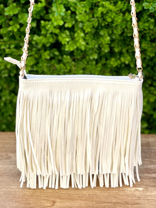 faux suede leather boho crossbody bag in white with adjustable strap and fun fringed style