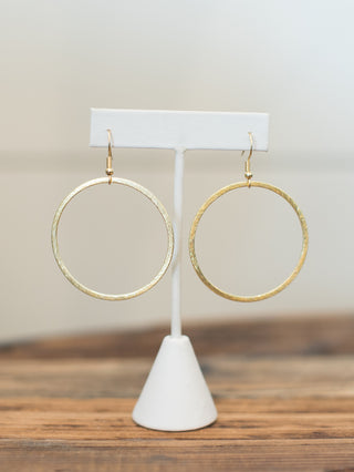 a pair of lightweight thin gold hoop dangle earrings perfect for everyday wear