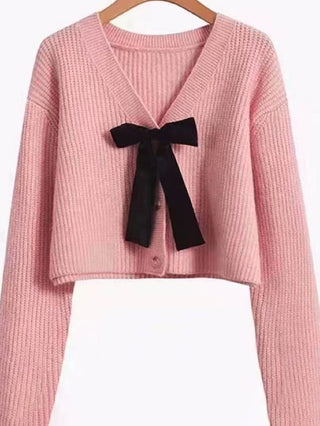 pink button up knit cardigan sweater with black bowtie 