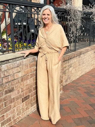 a pair of breezy light camel colored pants with an elastic waistband and tie worn with a matching colored top