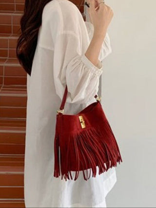 an adjustable red bucket fringe western style bag